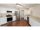 Modern kitchen featuring stainless steel appliances, white cabinets, and hardwood floors at 9481 Sw 93Rd Loop, Ocala, FL 34481