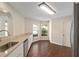 Kitchen featuring white cabinets, stainless steel appliances, granite counters, and hardwood floors at 9481 Sw 93Rd Loop, Ocala, FL 34481