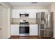 Well-lit kitchen featuring stainless steel appliances and white cabinetry at 9481 Sw 93Rd Loop, Ocala, FL 34481