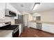 Open kitchen featuring white cabinets, granite countertops, and stainless steel appliances at 9481 Sw 93Rd Loop, Ocala, FL 34481