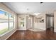 Open-concept living area featuring hardwood floors, a ceiling fan, and lots of natural light at 9481 Sw 93Rd Loop, Ocala, FL 34481