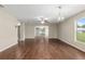 Spacious living room featuring wood-look flooring, modern ceiling fans, and ample natural light at 9481 Sw 93Rd Loop, Ocala, FL 34481