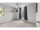 Neutral bedroom with a ceiling fan and a window with blue curtains and a wall shelf at 6300 Ave D, Mc Intosh, FL 32664