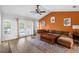 Cozy living room with vaulted ceilings, wood flooring, and natural light from the backyard patio doors at 6300 Ave D, Mc Intosh, FL 32664