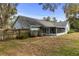 The rear exterior of the home showcasing the screened in porch and fenced in yard at 6300 Ave D, Mc Intosh, FL 32664