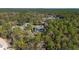 Aerial view of a home featuring a screened in pool, surrounded by trees at 12880 Sw 66Th St, Ocala, FL 34481