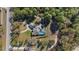 Single-story home with screened pool nestled amongst mature trees, providing privacy and a serene setting at 12880 Sw 66Th St, Ocala, FL 34481