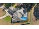 Aerial view of a single-story home featuring a screened pool and well-maintained landscaping at 12880 Sw 66Th St, Ocala, FL 34481