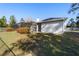 Exterior rear view of the home featuring a screened in pool and a black metal fence surrounding the yard at 12880 Sw 66Th St, Ocala, FL 34481