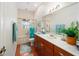 Bathroom with marble vanity, tile floors, and tub-shower combo with glass doors at 12880 Sw 66Th St, Ocala, FL 34481