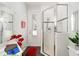 Bathroom featuring a glass-enclosed shower and access door to the exterior at 12880 Sw 66Th St, Ocala, FL 34481