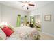 Bedroom with floral bedding, green accents, and a mirrored closet at 12880 Sw 66Th St, Ocala, FL 34481