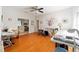 Spacious bonus room featuring hardwood floors, ceiling fan, and abundant natural light at 12880 Sw 66Th St, Ocala, FL 34481