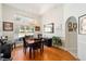 Charming dining room with large windows, chandelier, and hardwood floors at 12880 Sw 66Th St, Ocala, FL 34481