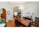 Open dining room with hardwood floors, elegant chandelier, and view into the living space at 12880 Sw 66Th St, Ocala, FL 34481