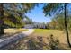 Exterior of a home featuring a well-manicured lawn, concrete driveway, and a three-car garage at 12880 Sw 66Th St, Ocala, FL 34481