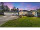 Exterior image featuring a manicured lawn, circular driveway, and three-car garage at 12880 Sw 66Th St, Ocala, FL 34481