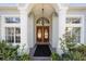 Inviting front entrance with decorative columns and double doors, surrounded by manicured plants at 12880 Sw 66Th St, Ocala, FL 34481
