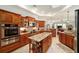 Gourmet kitchen with granite countertops, stainless steel appliances, and custom cabinetry at 12880 Sw 66Th St, Ocala, FL 34481