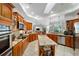 Spacious gourmet kitchen with granite counters, wood cabinets, and stainless steel appliances at 12880 Sw 66Th St, Ocala, FL 34481
