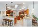 Bright kitchen featuring a breakfast bar, granite counters, and ample wood cabinet storage at 12880 Sw 66Th St, Ocala, FL 34481