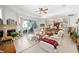 Bright living room with fireplace, tile floors, ceiling fan, and sliding glass doors to the outdoor patio at 12880 Sw 66Th St, Ocala, FL 34481