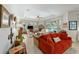 Open-concept living room with fireplace, comfortable seating, and plenty of natural light at 12880 Sw 66Th St, Ocala, FL 34481
