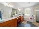 Luxurious main bathroom featuring dual sinks, vanity, garden tub, and shower at 12880 Sw 66Th St, Ocala, FL 34481