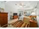 Comfortable main bedroom featuring a tray ceiling, and sitting area with pool view at 12880 Sw 66Th St, Ocala, FL 34481