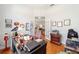 Well-lit office featuring hardwood floors, neutral walls, and a view into the living room at 12880 Sw 66Th St, Ocala, FL 34481