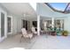 Covered patio with fans and furniture overlooking the pool and yard at 12880 Sw 66Th St, Ocala, FL 34481