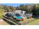 Aerial view of a screened-in pool with a black metal fence and shrubbery surrounding the perimeter at 12880 Sw 66Th St, Ocala, FL 34481