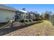 Backyard view of a screened in pool and patio with landscaping and partial fencing at 12880 Sw 66Th St, Ocala, FL 34481