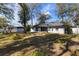 A fully fenced backyard with mature trees and a storage shed at 1762 Ne 39Th St, Ocala, FL 34479