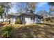 Back exterior view of home with a large yard and mature plants at 1762 Ne 39Th St, Ocala, FL 34479