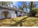 Back exterior view of home with fenced in yard and a mature tree at 1762 Ne 39Th St, Ocala, FL 34479