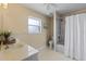 Bright bathroom with tub and shower combo, white cabinets, and neutral walls at 1762 Ne 39Th St, Ocala, FL 34479