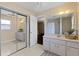 Spacious bathroom with double sinks, vanity, large mirror, and walk-in shower at 1762 Ne 39Th St, Ocala, FL 34479