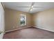 Neutral bedroom with tan carpet, blank walls, and a double door closet at 1762 Ne 39Th St, Ocala, FL 34479