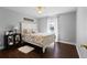 Bedroom with hardwood floors, a white framed bed, and an open window at 1762 Ne 39Th St, Ocala, FL 34479