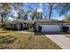 Charming single-story home featuring a well-maintained lawn and a two-car garage at 1762 Ne 39Th St, Ocala, FL 34479