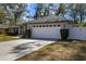 Exterior view of a home showcasing the large two-car garage and driveway at 1762 Ne 39Th St, Ocala, FL 34479