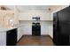 Well-lit kitchen featuring white cabinets, essential appliances, and a practical layout at 1762 Ne 39Th St, Ocala, FL 34479