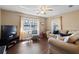 Cozy living room features wood floors, natural light, and a ceiling fan at 1762 Ne 39Th St, Ocala, FL 34479