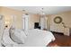 Neutral main bedroom featuring hardwood floors, ensuite bathroom, and closet at 1762 Ne 39Th St, Ocala, FL 34479