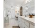 Bathroom featuring double mirrors, vanity, jacuzzi, and separate toilet closet at 906 Crestview Dr, Auburndale, FL 33823