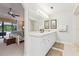 Bathroom featuring double vanity sinks, walk-in shower, and access to the Primary bedroom at 906 Crestview Dr, Auburndale, FL 33823