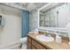 Bathroom with a shower featuring floral wallpaper and wood vanity at 906 Crestview Dr, Auburndale, FL 33823