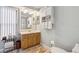 Bright bathroom featuring a vintage vanity and a large mirror, complemented by stylish fixtures and decor at 906 Crestview Dr, Auburndale, FL 33823