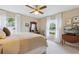 Bright, airy bedroom with a large bed, ceiling fan, and picturesque windows at 906 Crestview Dr, Auburndale, FL 33823